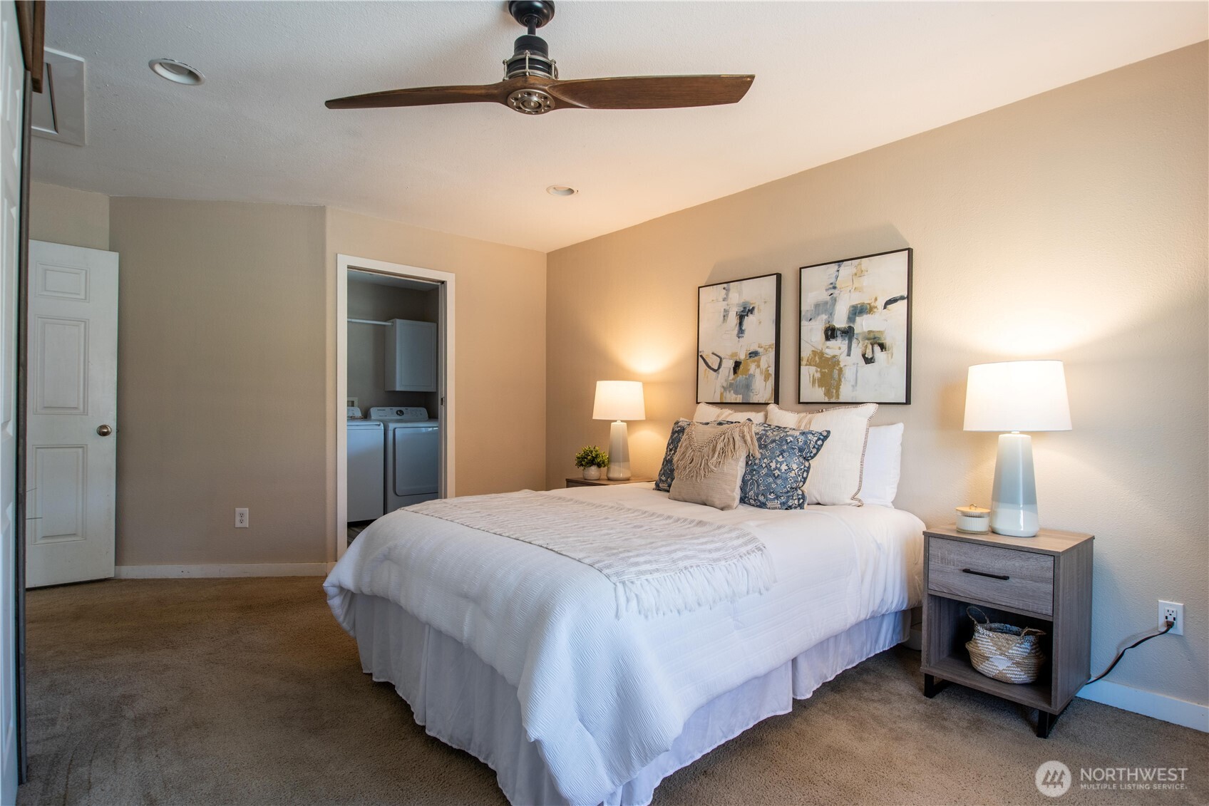 1610 16th Street Sumner, WA 98390 - Photo 10 of 28 a bedroom with a bed and a chandelier