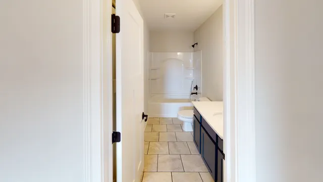 a bathroom with a glass door shower and a sink