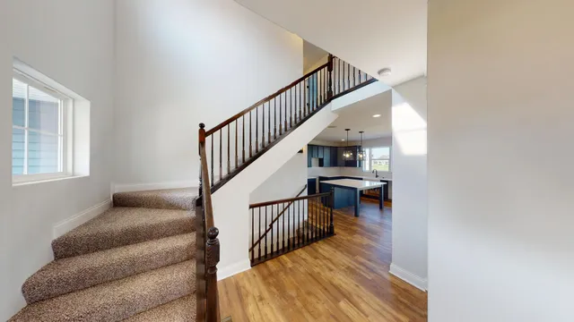 a view of entryway and hall with wooden floor