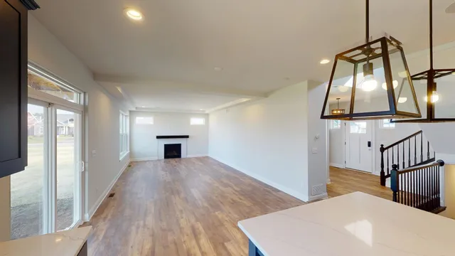 a view of a livingroom with wooden floor and furniture