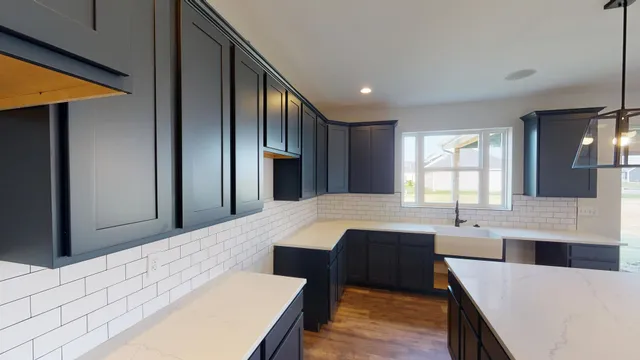 a large kitchen with a table and chairs
