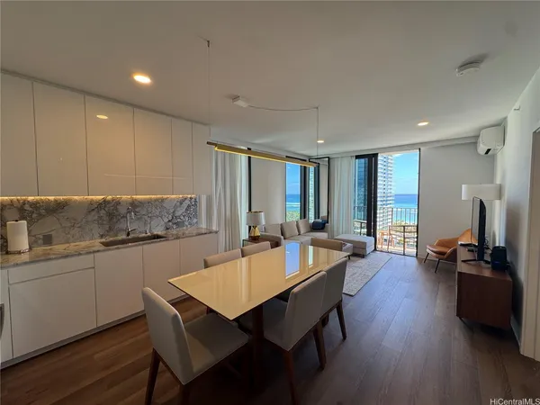 a kitchen with a table chairs stove and wooden floor