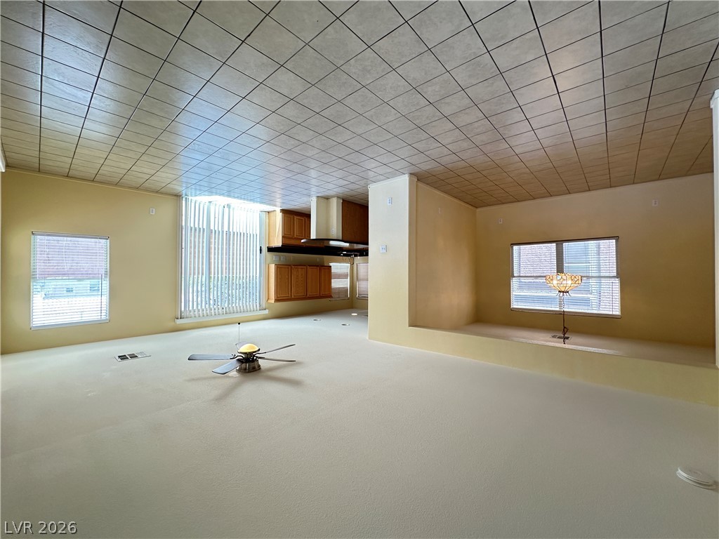 9032 Rutherford Grove Street Las Vegas, NV 89148 - Photo 7 of 24 A spacious open-concept area offers ample natural illumination and seamless flow for entertaining.