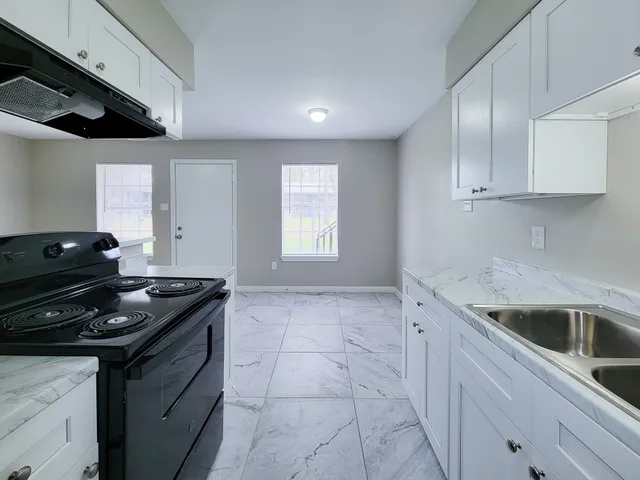 a kitchen that has a sink and a stove