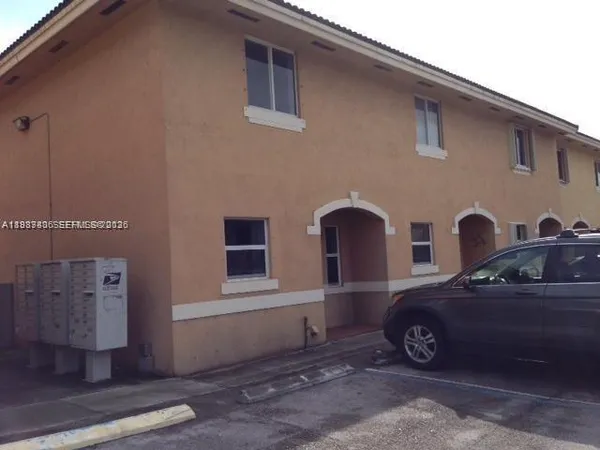 a front view of a house with parking space