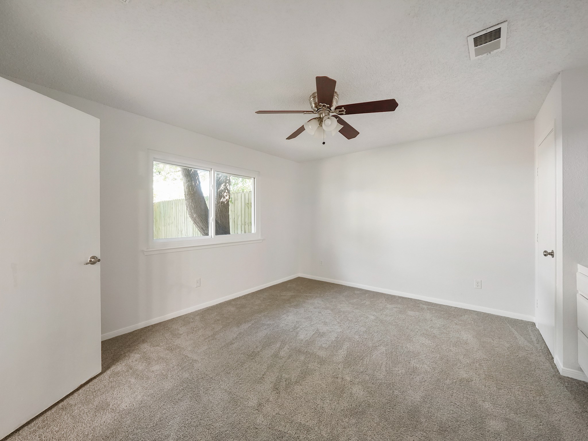 23338 Prairie Bird Drive Spring, TX 77373 - Photo 17 of 21 an empty room with a window and a fan