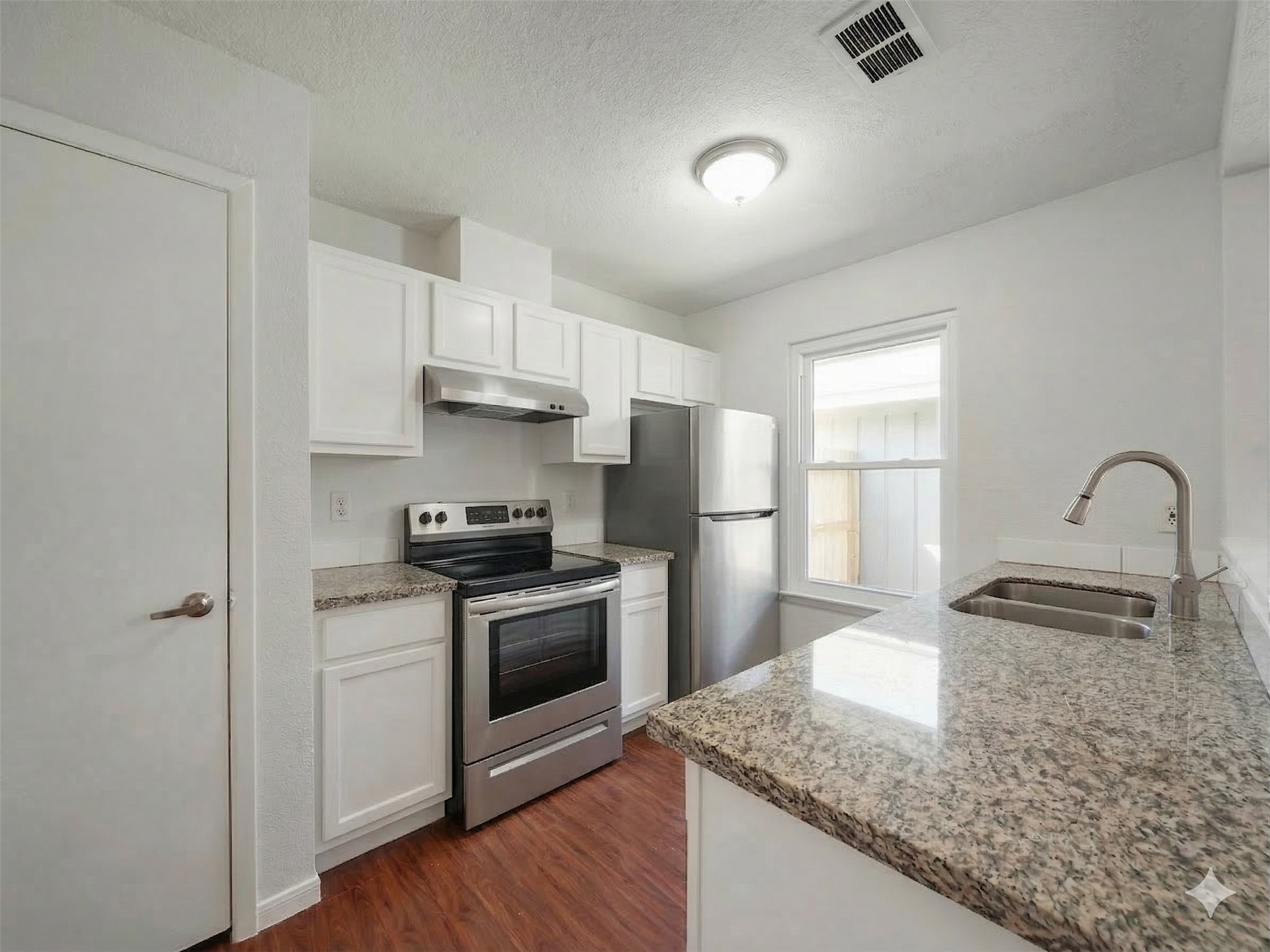 23338 Prairie Bird Drive Spring, TX 77373 - Photo 6 of 21 a kitchen with stainless steel appliances granite countertop a sink stove and refrigerator