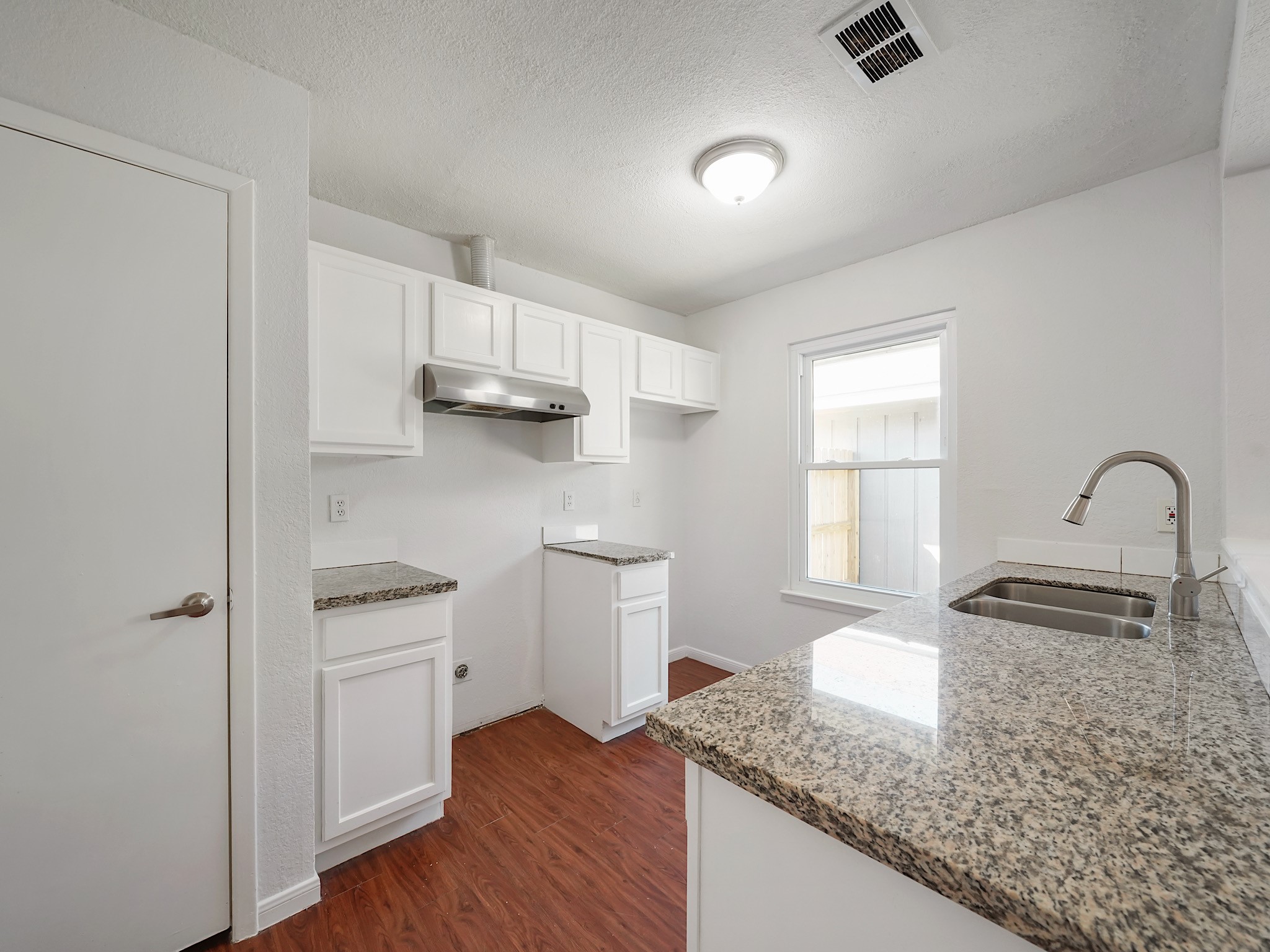 23338 Prairie Bird Drive Spring, TX 77373 - Photo 7 of 21 a kitchen with a sink cabinets and wooden floor