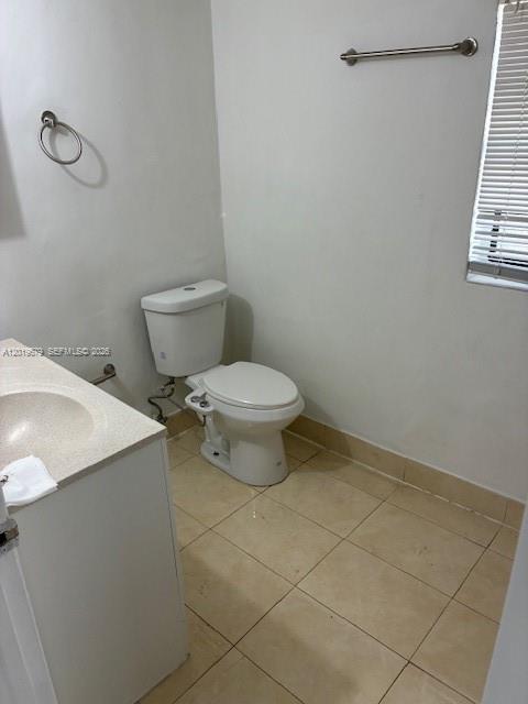 420 88th Street Surfside, FL 33154 - Photo 28 of 33 a white toilet sitting next to a white sink and vanity