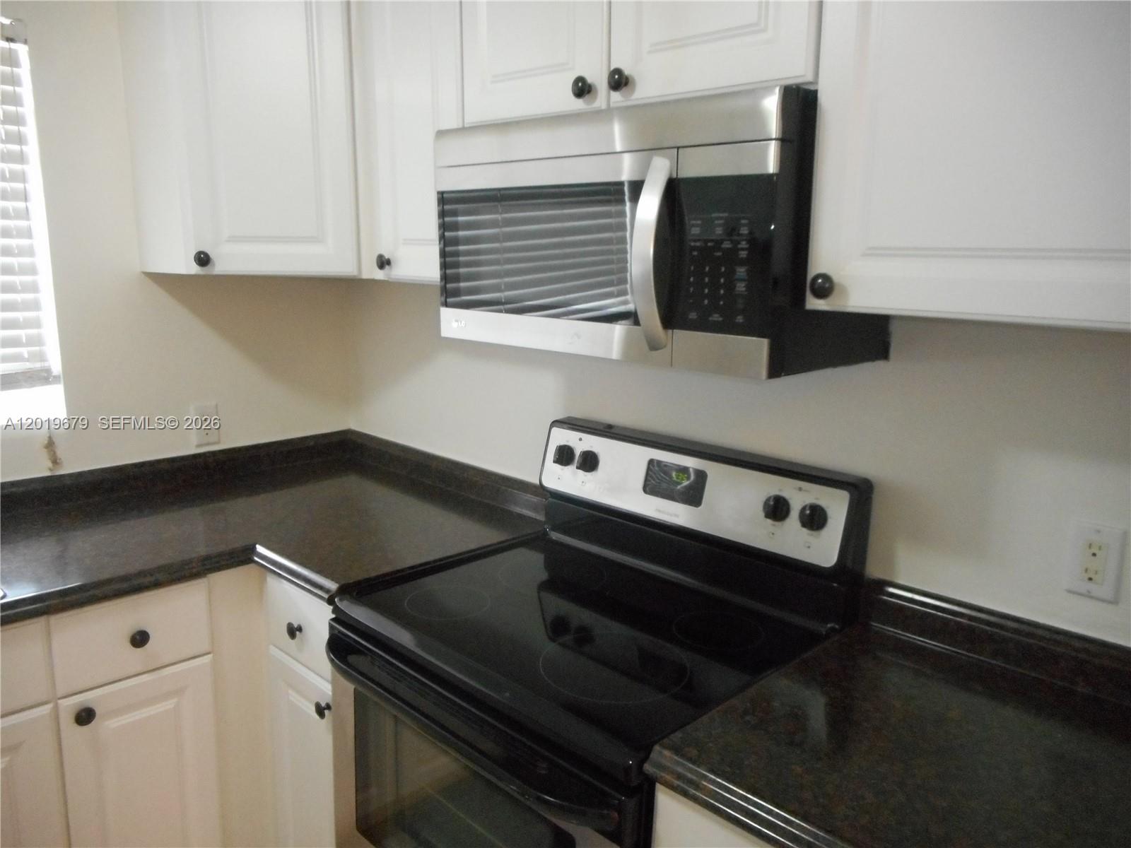 420 88th Street Surfside, FL 33154 - Photo 9 of 33 a stove top oven sitting inside of a kitchen