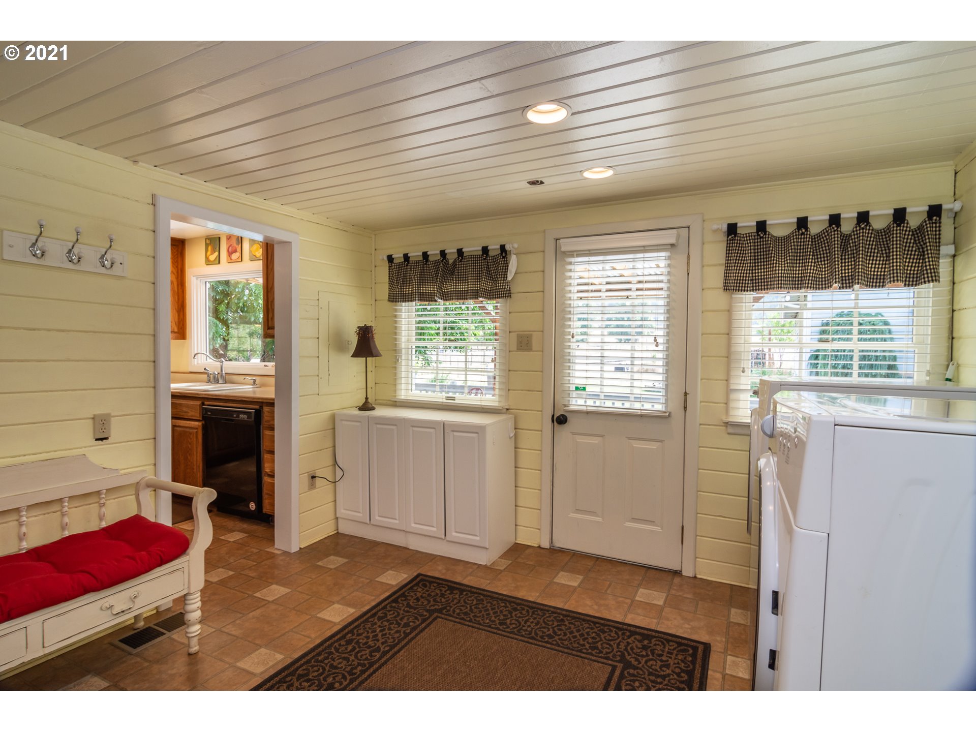 5852 Scotts Valley Road Yoncalla, OR 97499 - Photo 14 of 32 a hallway with a large window and wooden floor