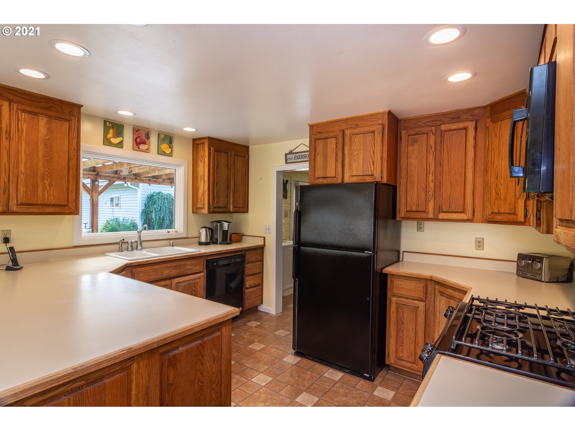 5852 Scotts Valley Road Yoncalla, OR 97499 - Photo 17 of 32 a kitchen with a refrigerator a stove a sink dishwasher and cabinets with wooden floor