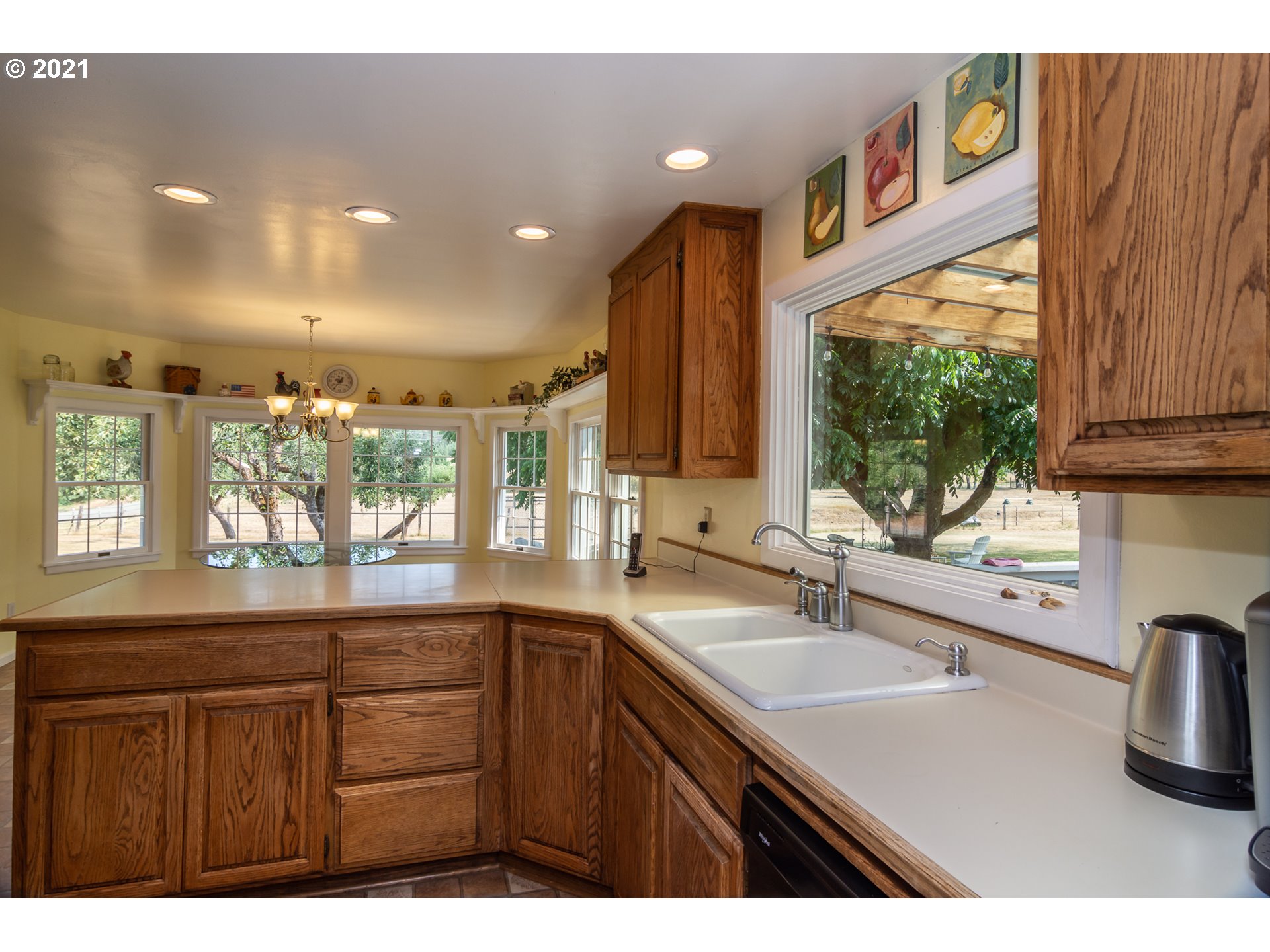 5852 Scotts Valley Road Yoncalla, OR 97499 - Photo 19 of 32 a kitchen with a sink a window and cabinets