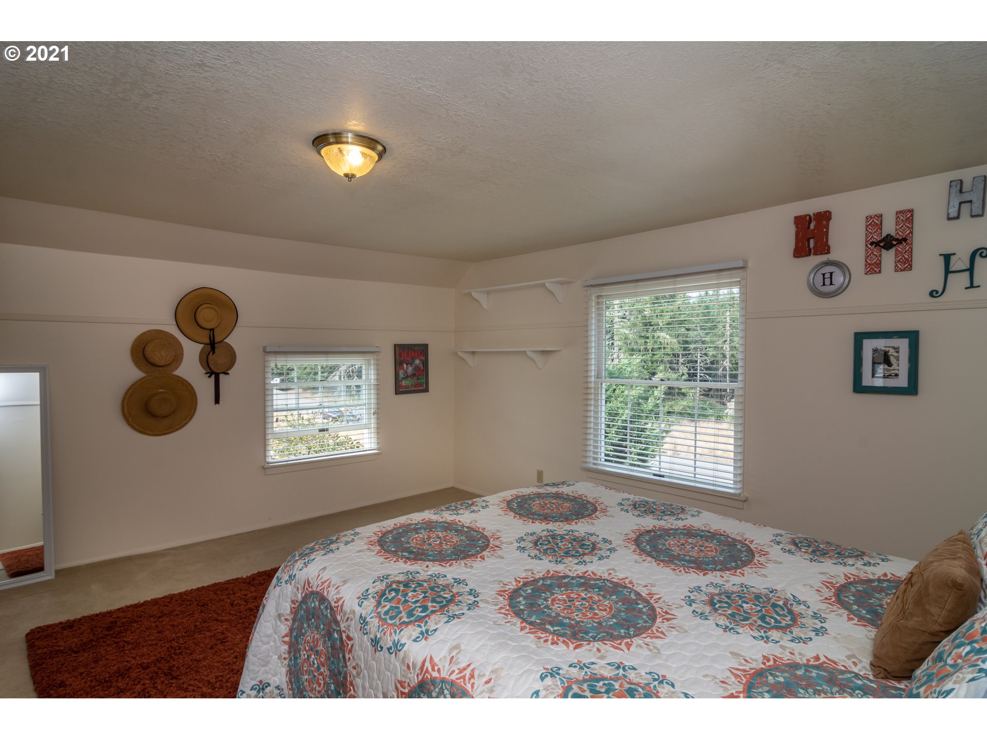 5852 Scotts Valley Road Yoncalla, OR 97499 - Photo 29 of 32 a bedroom with a bed and a window