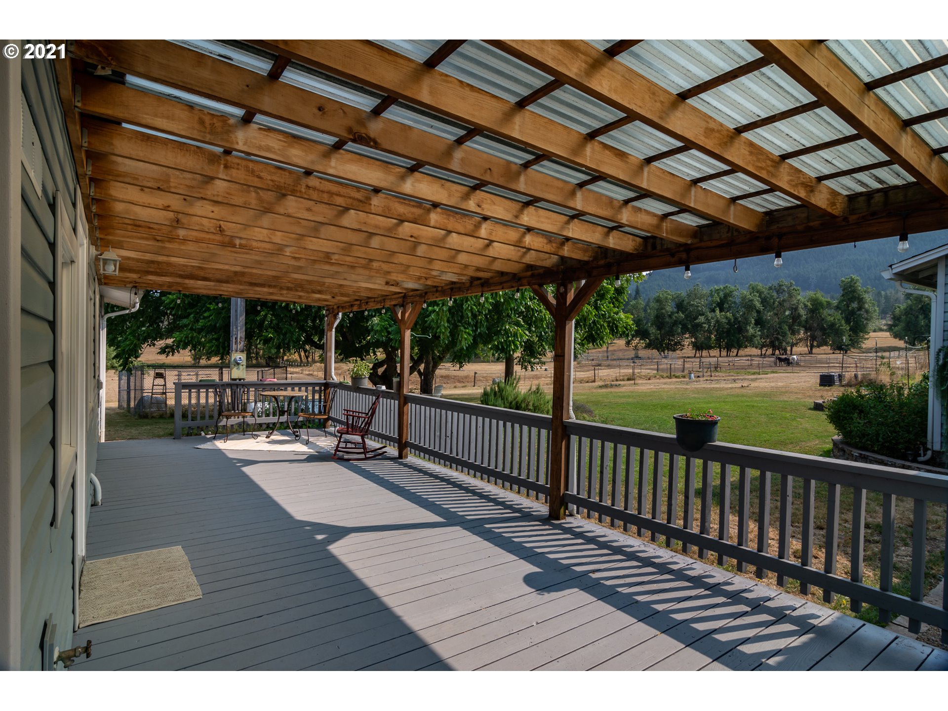 5852 Scotts Valley Road Yoncalla, OR 97499 - Photo 7 of 32 a patio view with a table and chairs a barbeque with wooden fence