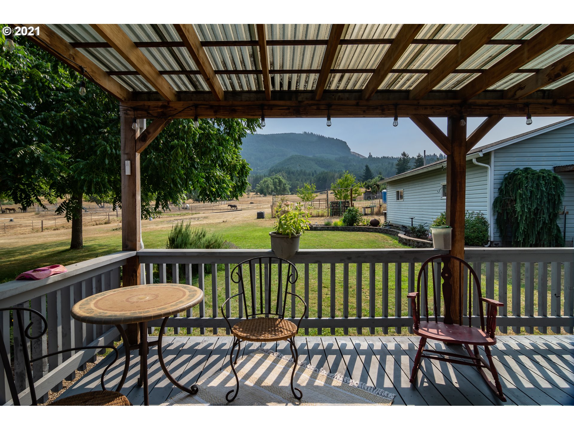 5852 Scotts Valley Road Yoncalla, OR 97499 - Photo 9 of 32 a view of a chairs and table in the patio