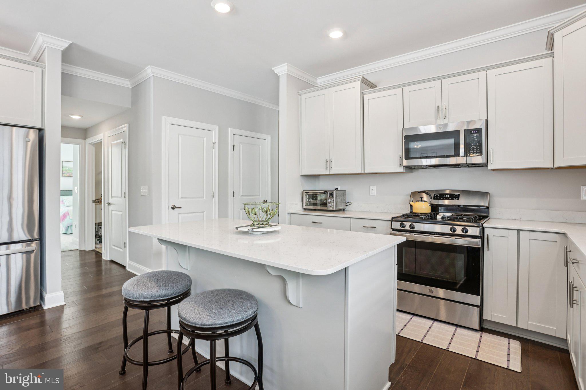 38 Tower Boulevard Mount Holly, NJ 08060 - Photo 19 of 42 a kitchen with stainless steel appliances a stove a sink cabinets and a dining table
