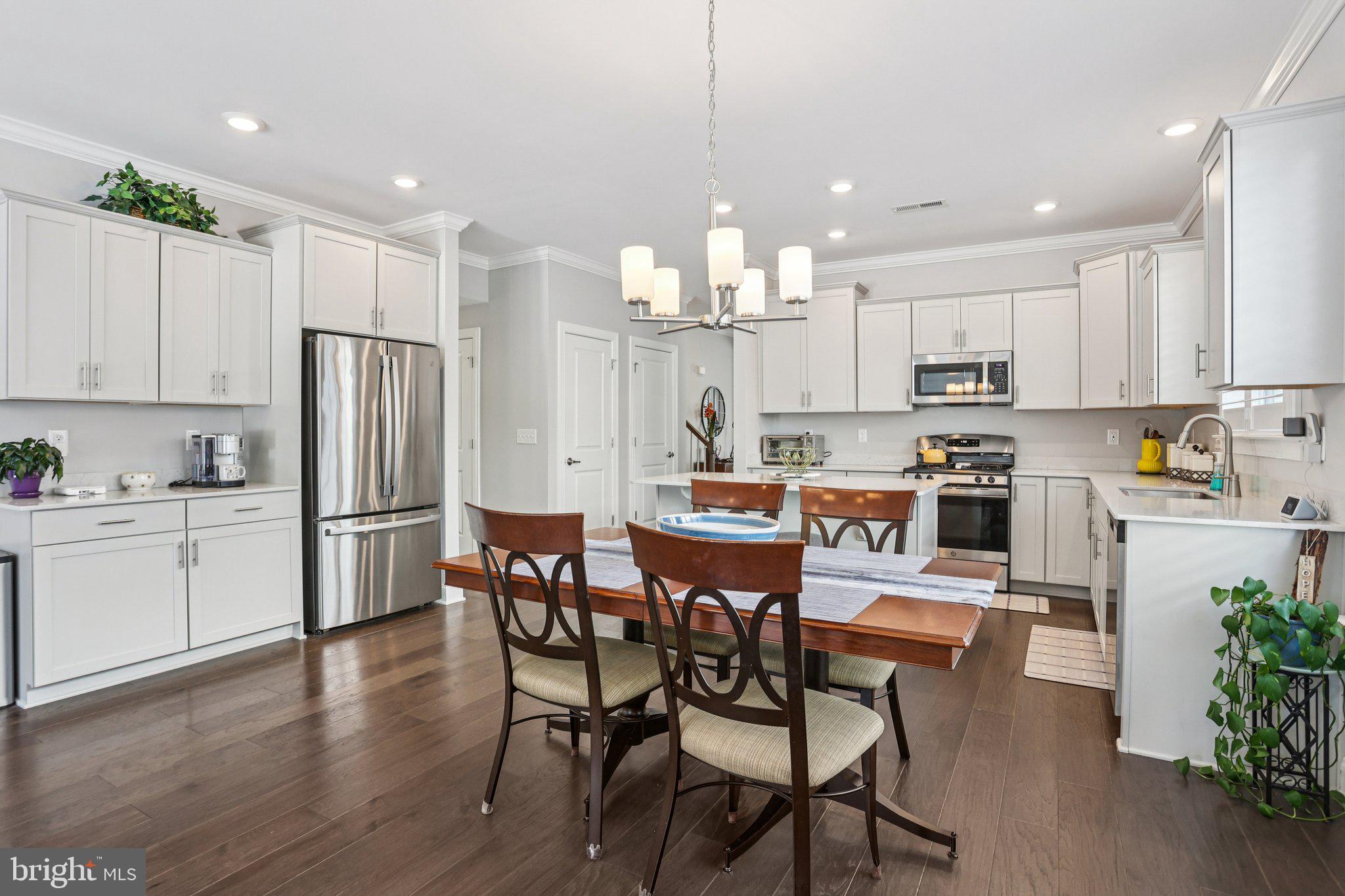 38 Tower Boulevard Mount Holly, NJ 08060 - Photo 20 of 42 a kitchen with a dining table chairs wooden floor cabinets and stainless steel appliances