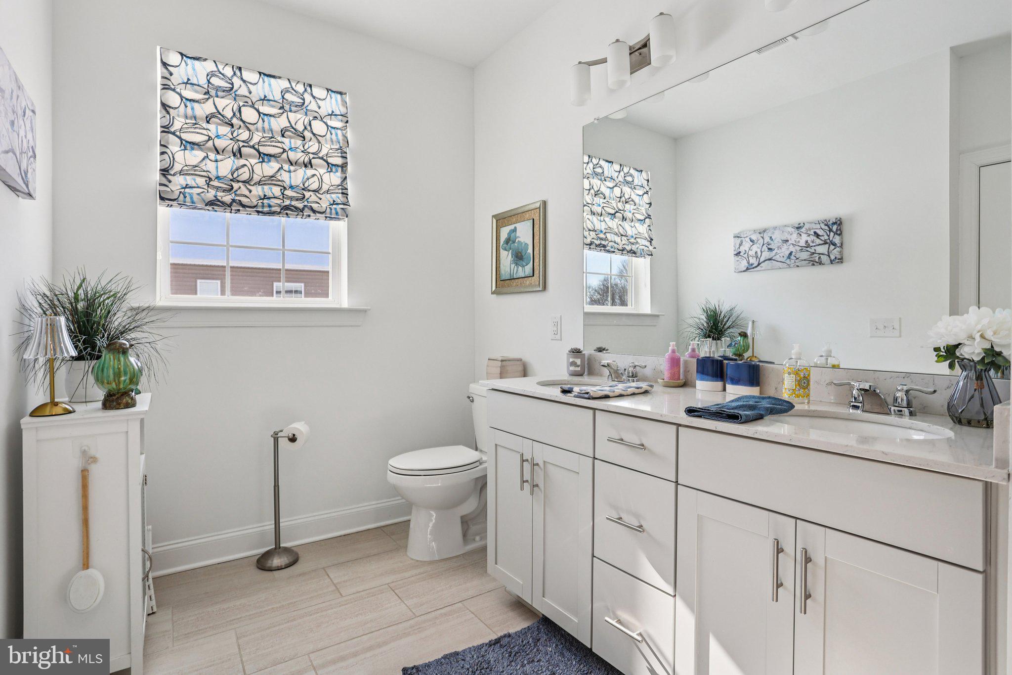38 Tower Boulevard Mount Holly, NJ 08060 - Photo 27 of 42 a bathroom with a toilet sink and mirror
