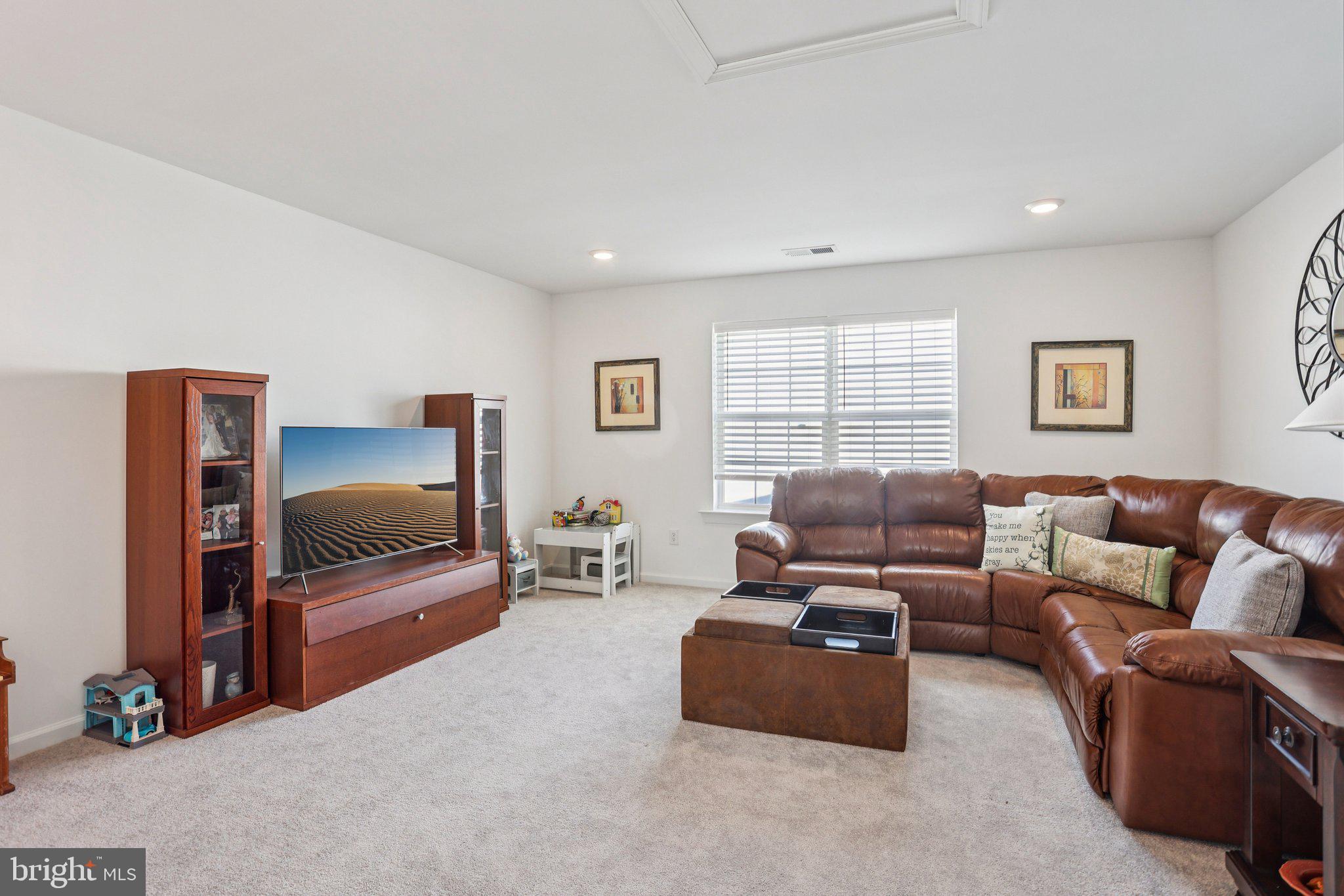 38 Tower Boulevard Mount Holly, NJ 08060 - Photo 33 of 42 a living room with furniture a flat screen tv and gym equipment