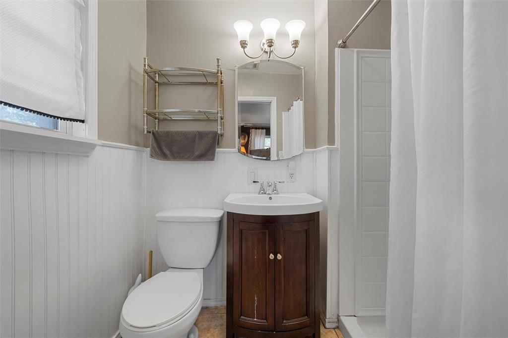 6224 Summit Ridge Drive Waco, TX 76710 - Photo 13 of 25 a bathroom with a toilet a sink a mirror and vanity