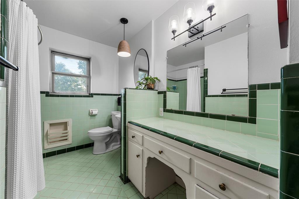 6224 Summit Ridge Drive Waco, TX 76710 - Photo 16 of 25 a bathroom with a sink a toilet and mirror