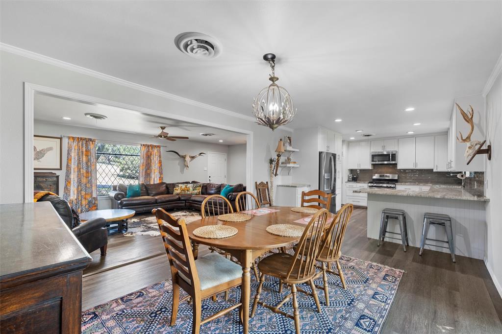 6224 Summit Ridge Drive Waco, TX 76710 - Photo 7 of 25 a dining room with wooden floor a chandelier a wooden table and chairs