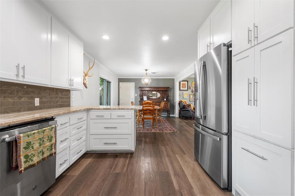 6224 Summit Ridge Drive Waco, TX 76710 - Photo 10 of 25 a kitchen with white cabinets and stainless steel appliances