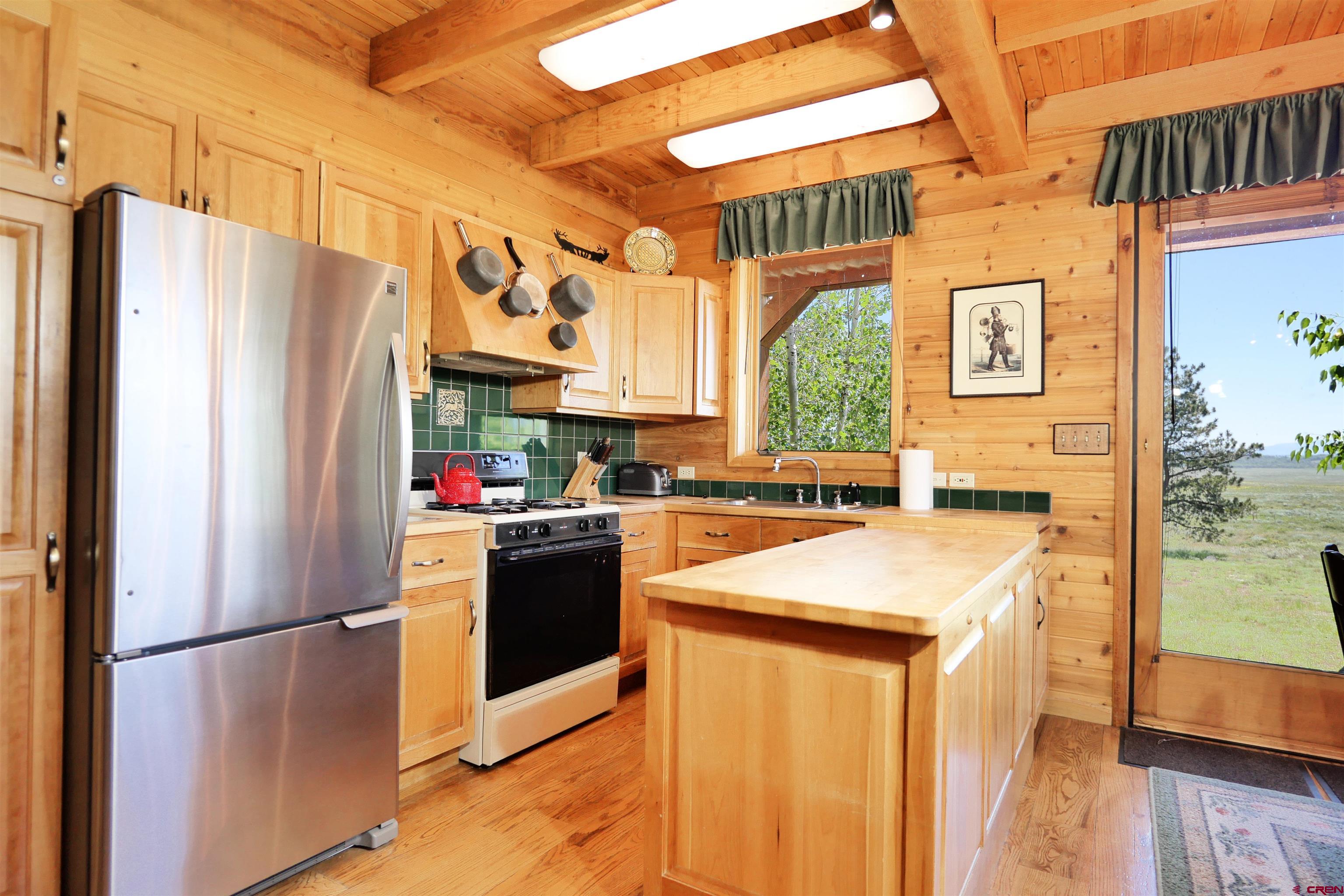 2425 62x Road Placerville, CO 81430 - Photo 14 of 30 a kitchen with stainless steel appliances granite countertop a refrigerator a sink and a stove