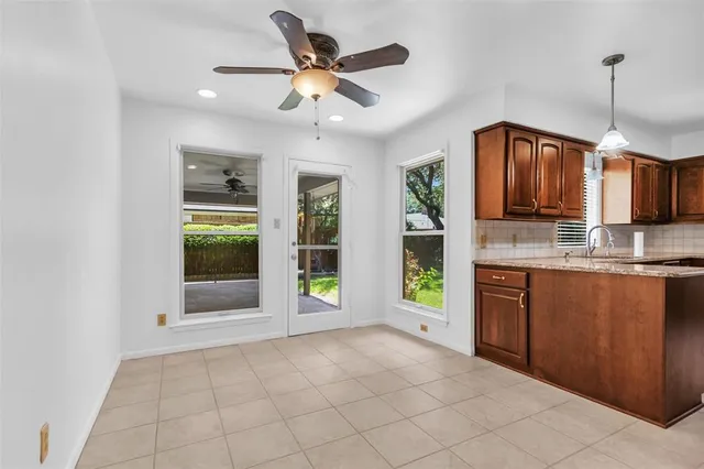 a open kitchen with stainless steel appliances granite countertop a refrigerator a sink a stove and a wooden cabinets