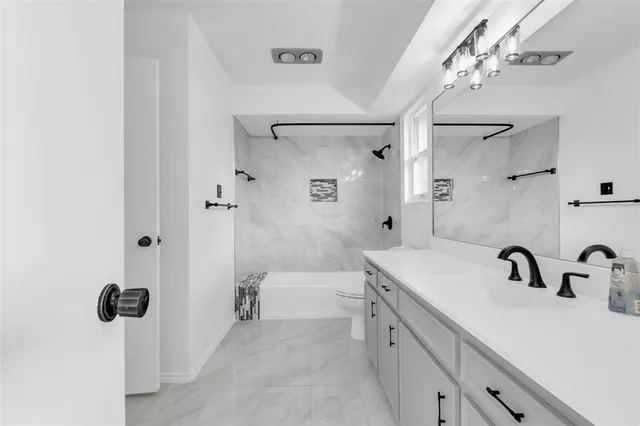 a bathroom with a sink double vanity and shower