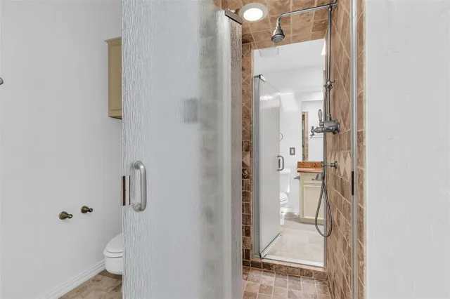 a bathroom with a glass shower door