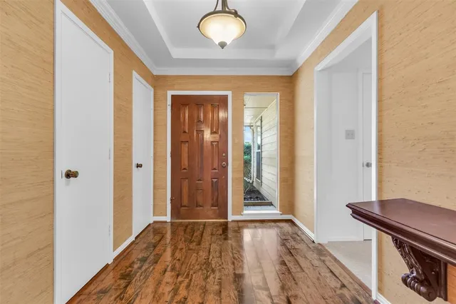 a view of a livingroom with wooden floor and staircase