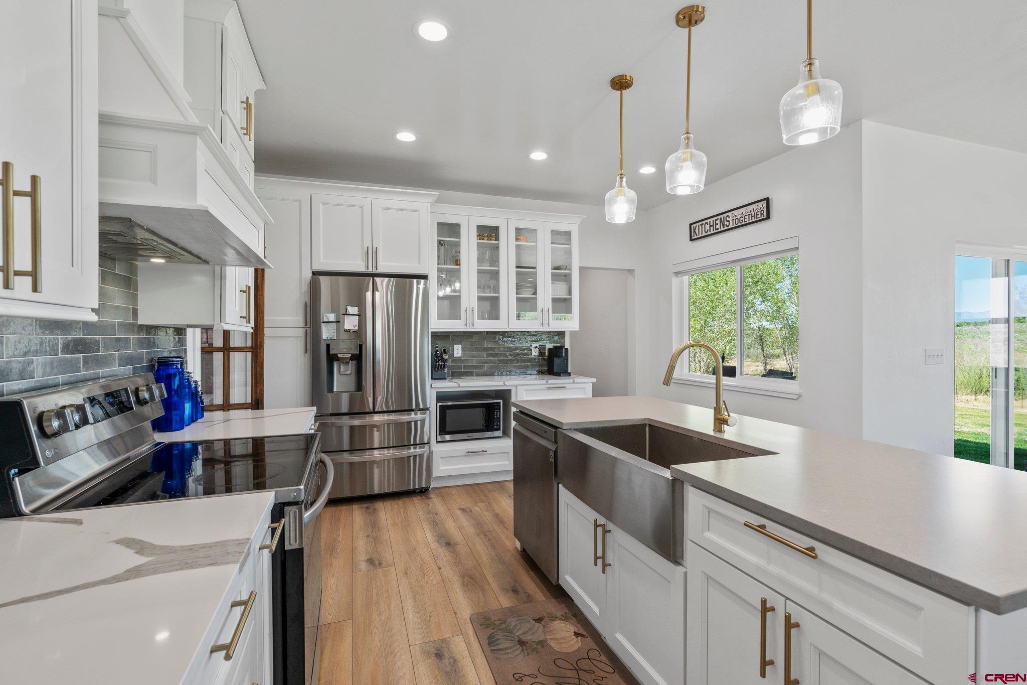 1517 Golf Course Lane Cortez, CO 81321 - Photo 12 of 41 a kitchen with stainless steel appliances granite countertop a sink refrigerator and microwave