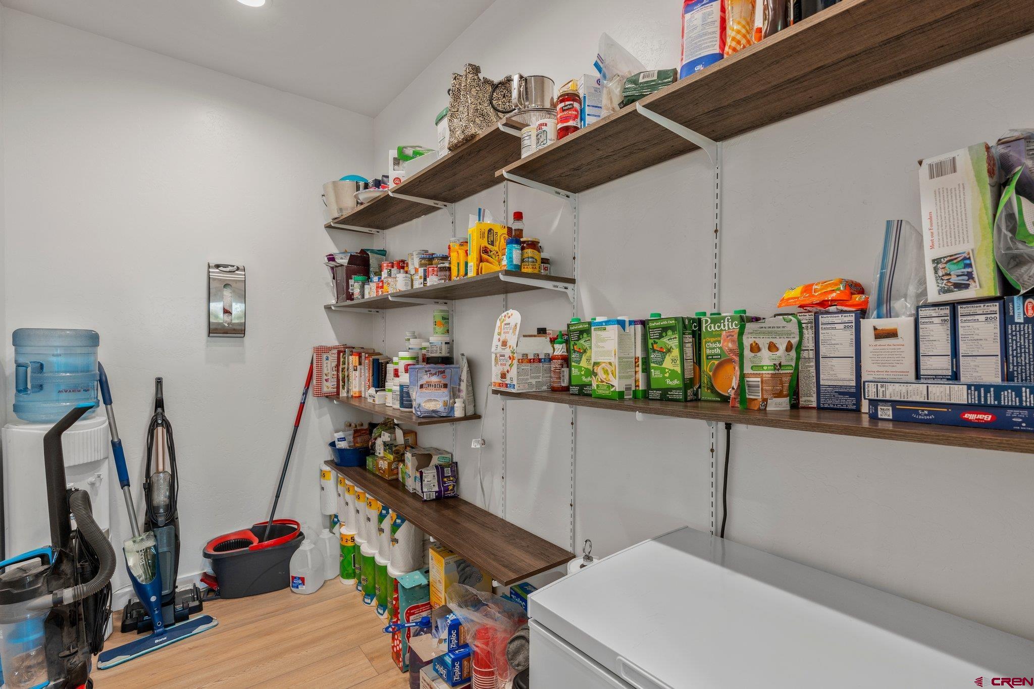 1517 Golf Course Lane Cortez, CO 81321 - Photo 13 of 41 a storage room with washer and lots of wooden furniture