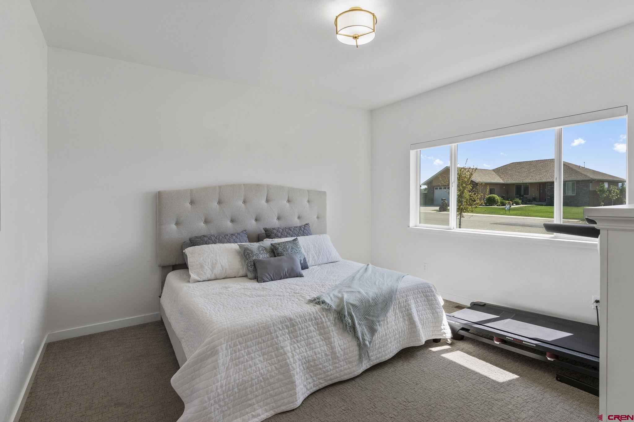 1517 Golf Course Lane Cortez, CO 81321 - Photo 15 of 41 a bedroom with a bed and window