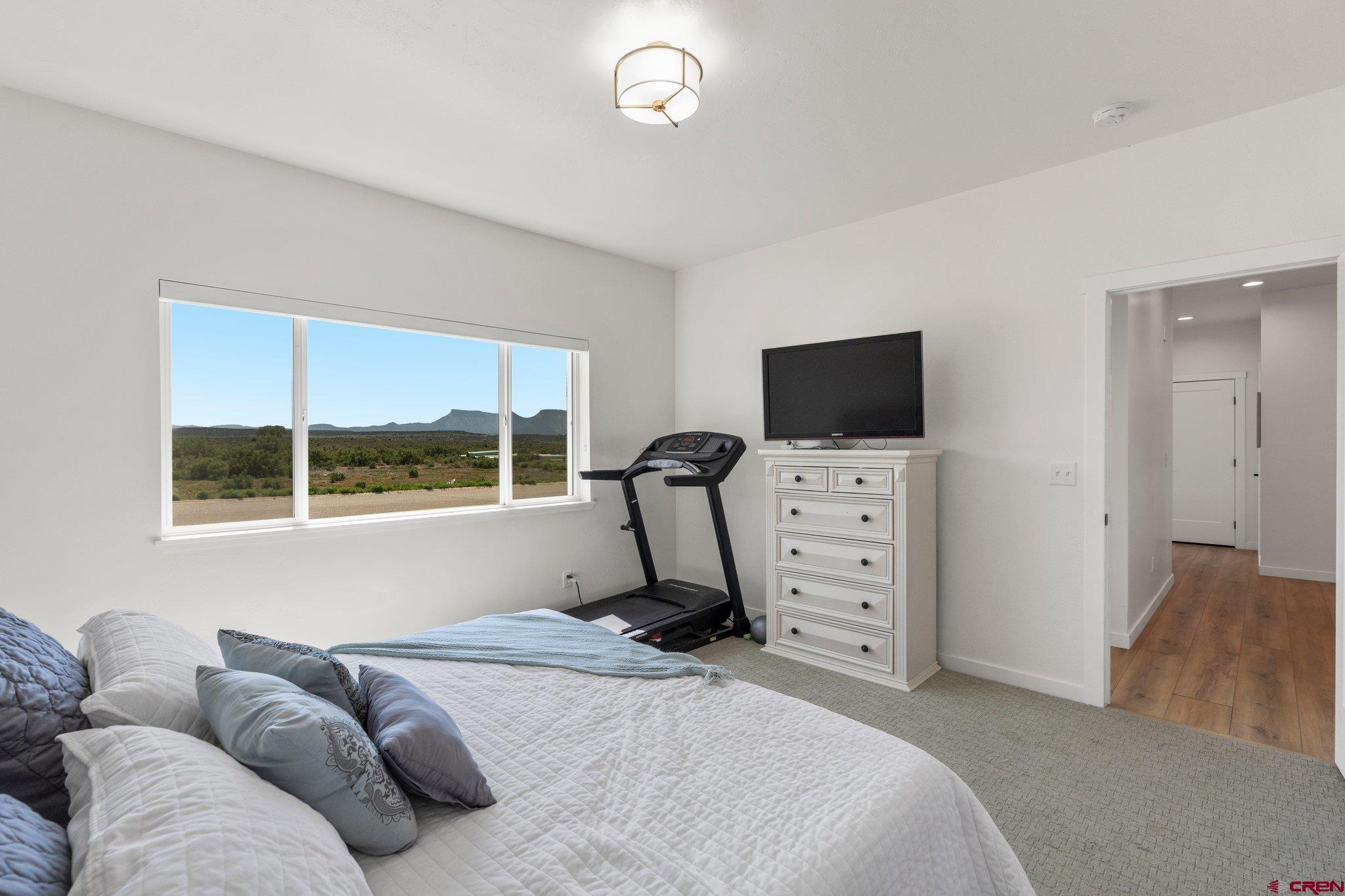 1517 Golf Course Lane Cortez, CO 81321 - Photo 16 of 41 a bedroom with furniture and a flat screen tv