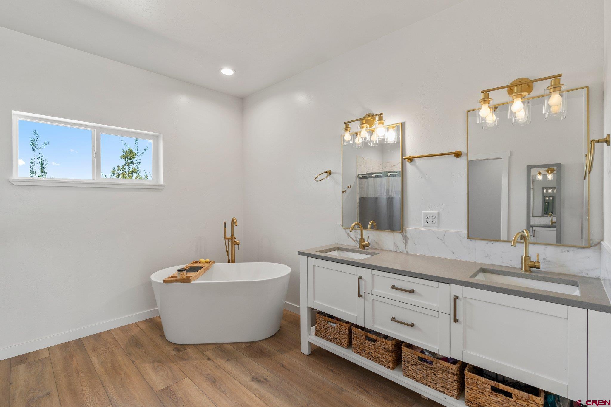 1517 Golf Course Lane Cortez, CO 81321 - Photo 20 of 41 a bathroom with a white tub a sink and mirror