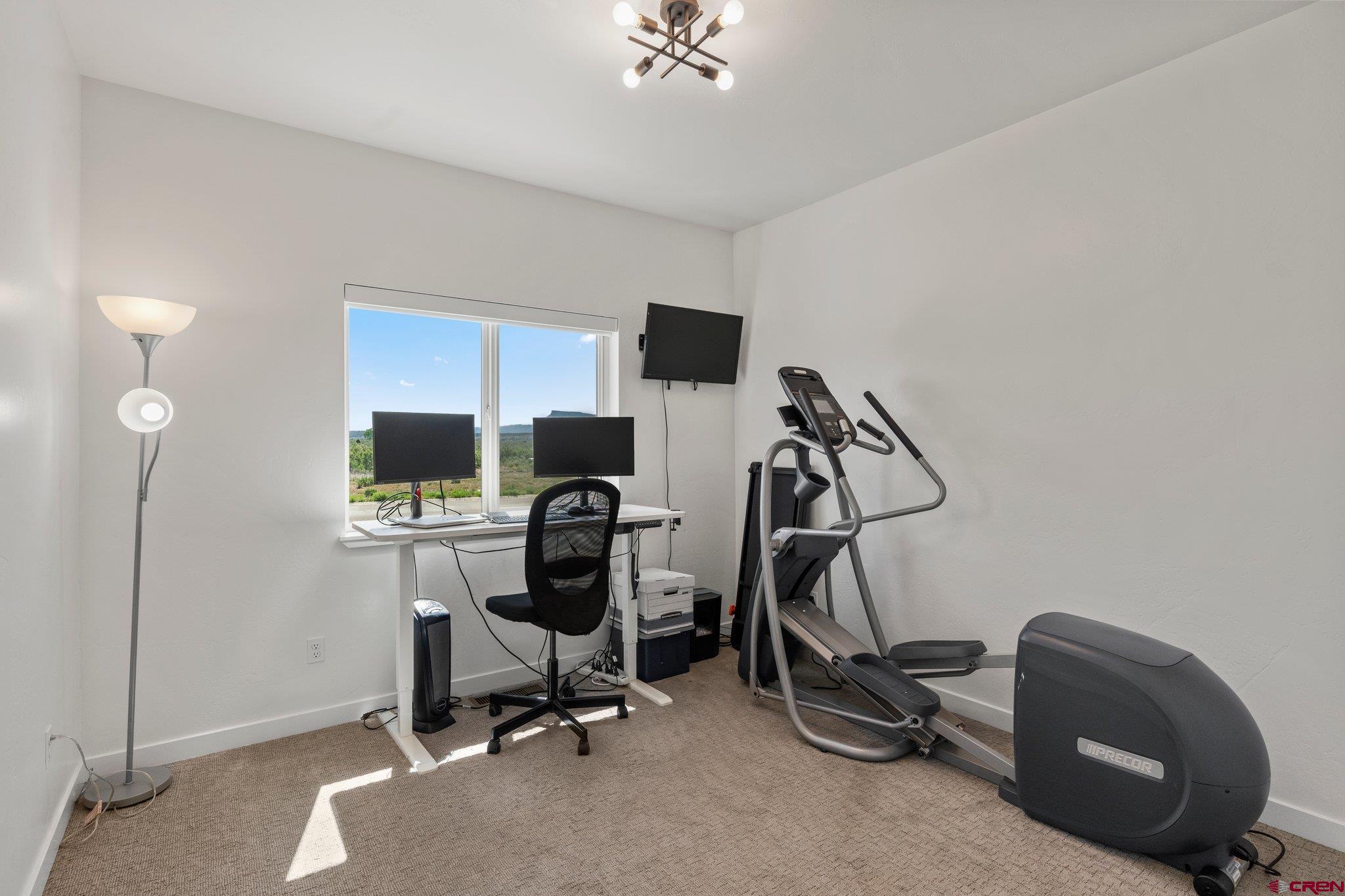 1517 Golf Course Lane Cortez, CO 81321 - Photo 22 of 41 a view of a workspace with furniture and a air conditioner