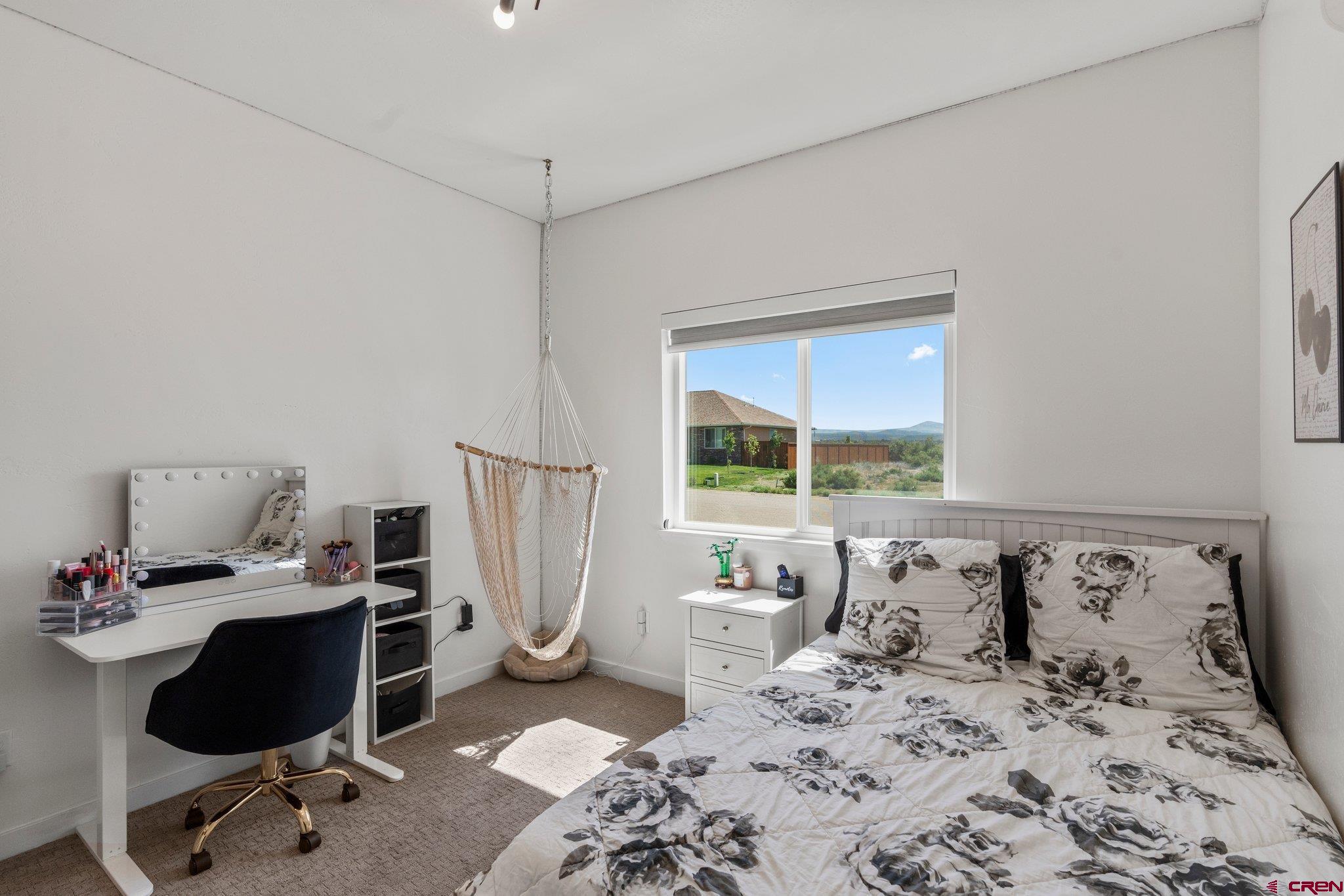 1517 Golf Course Lane Cortez, CO 81321 - Photo 24 of 41 a bedroom with furniture and a window