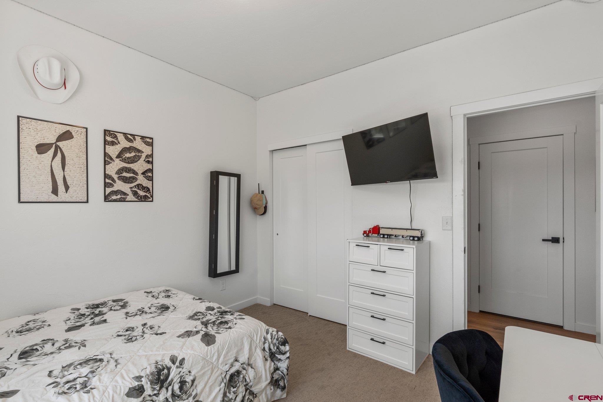 1517 Golf Course Lane Cortez, CO 81321 - Photo 25 of 41 a bedroom with a bed and a flat screen tv