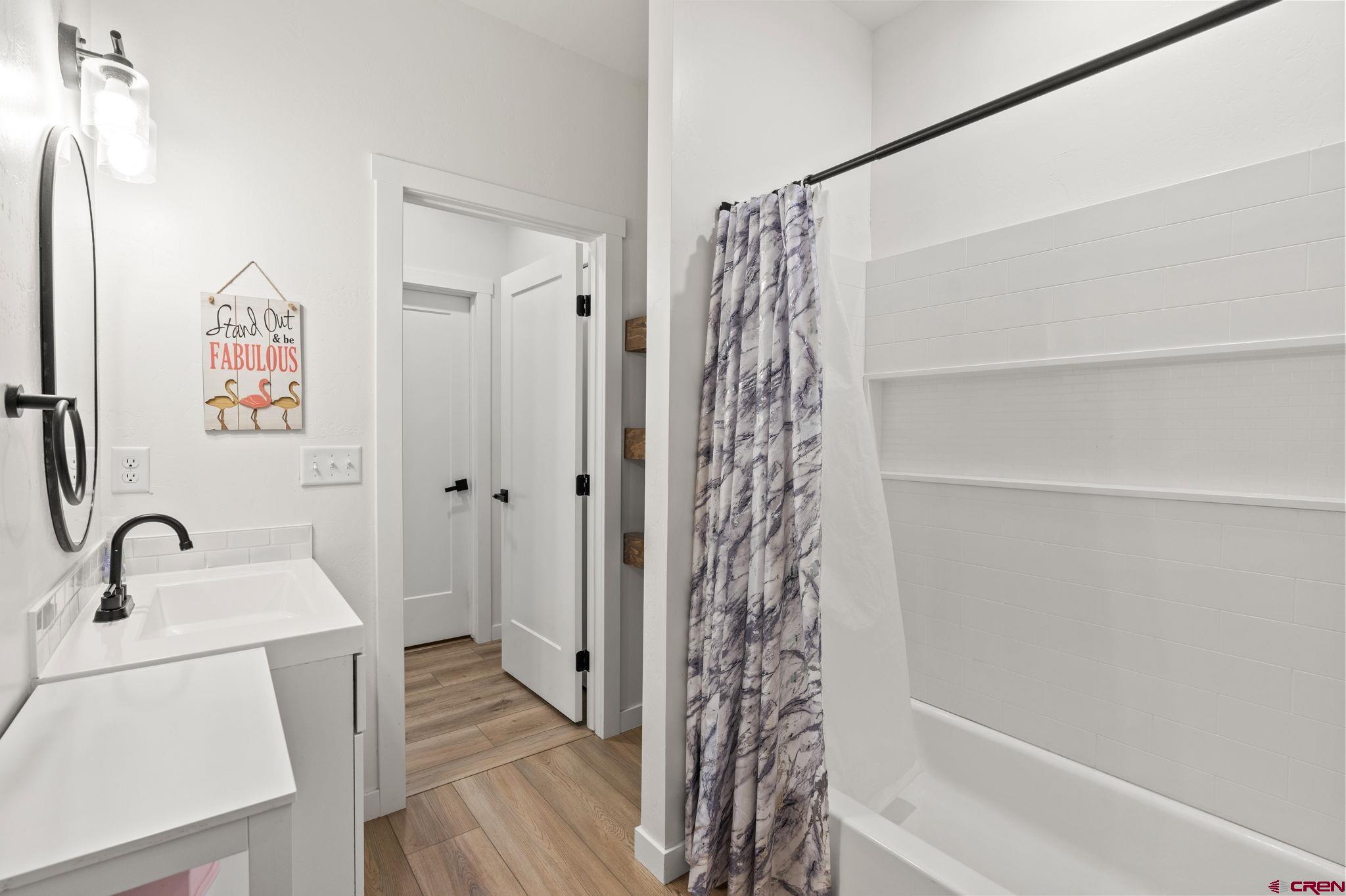 1517 Golf Course Lane Cortez, CO 81321 - Photo 28 of 41 a bathroom with a sink a toilet and shower