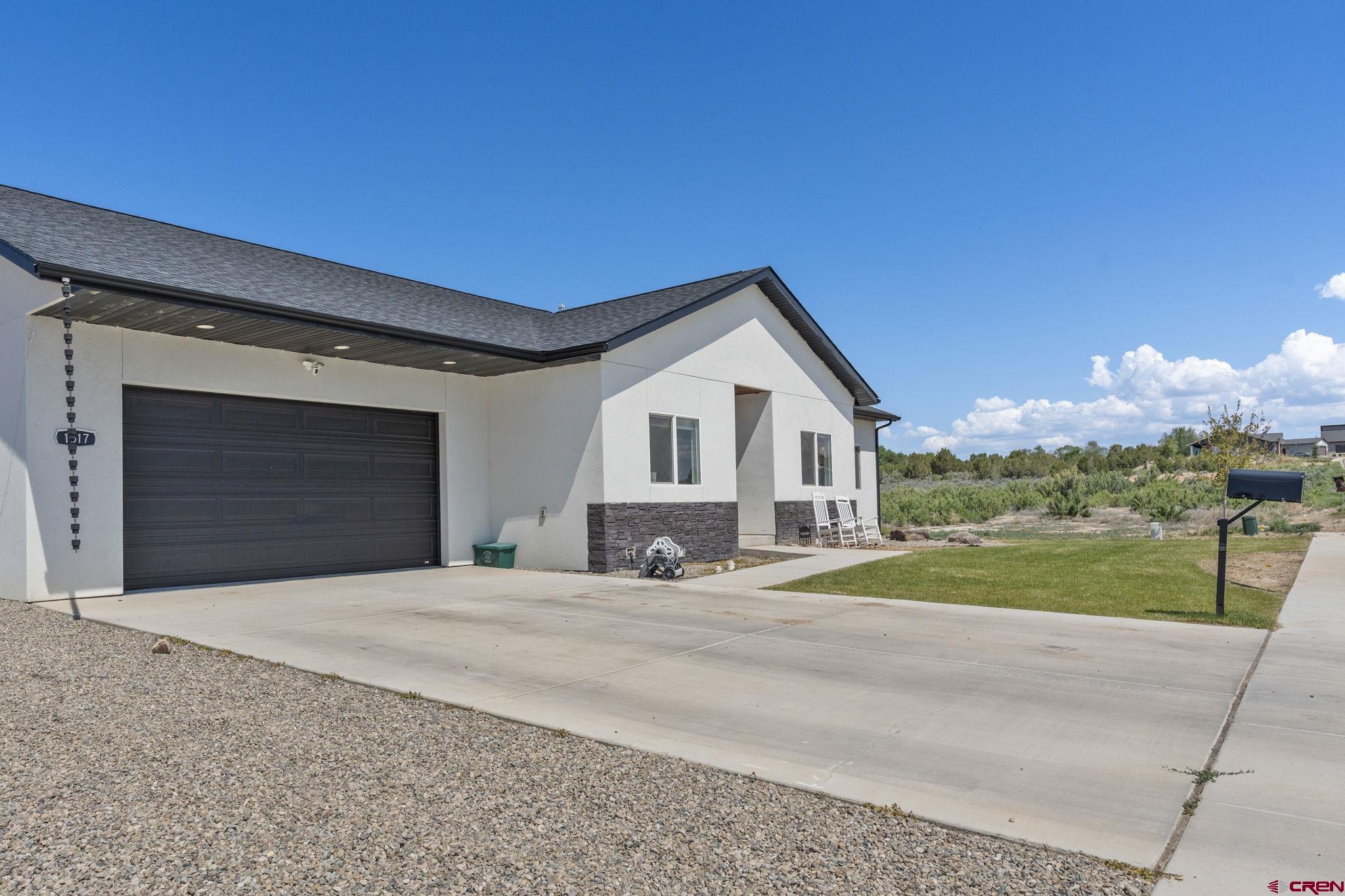 1517 Golf Course Lane Cortez, CO 81321 - Photo 33 of 41 a front view of a house with a yard and garage