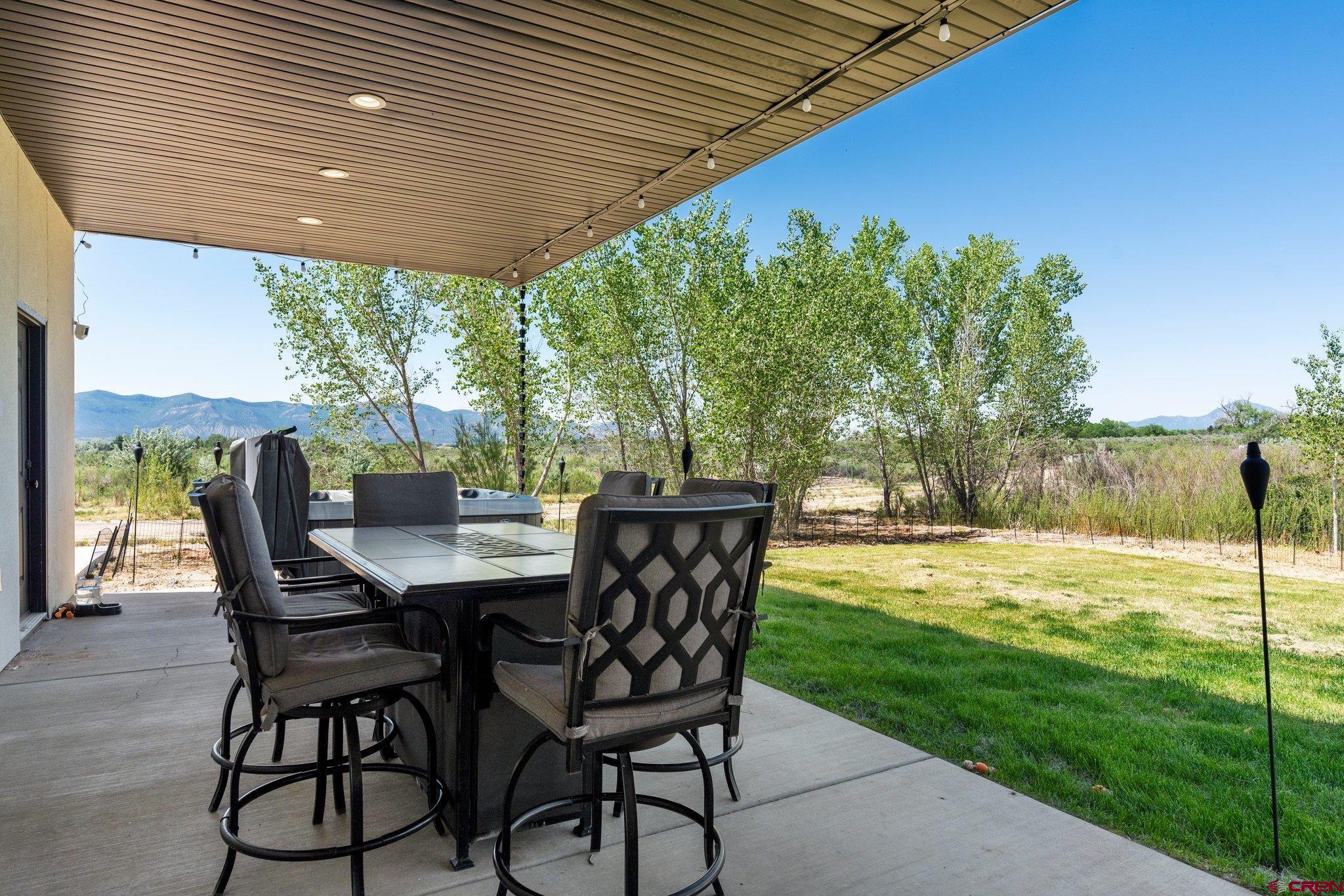 1517 Golf Course Lane Cortez, CO 81321 - Photo 34 of 41 a view of a patio with a table chairs and backyard