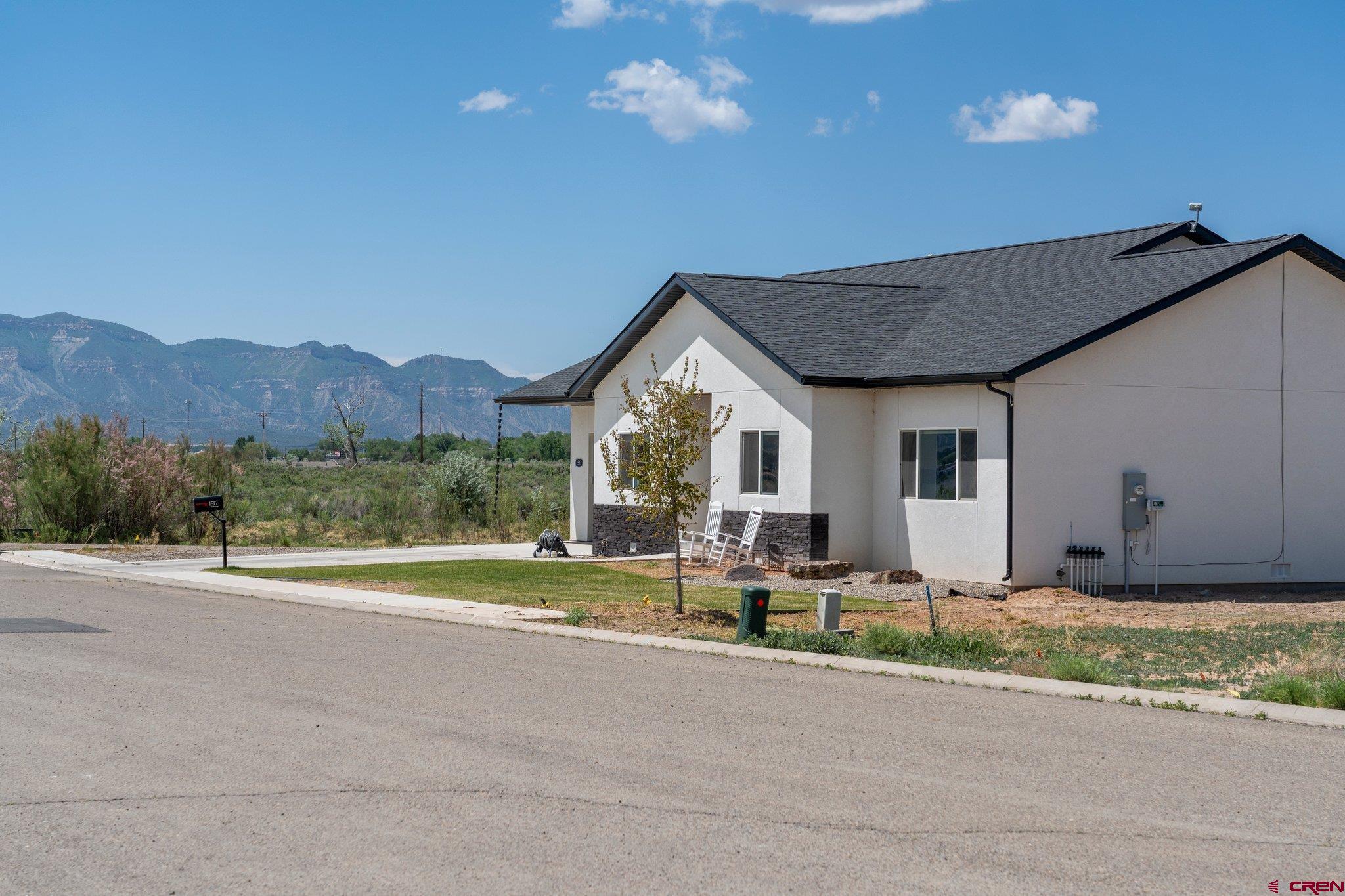 1517 Golf Course Lane Cortez, CO 81321 - Photo 40 of 41 a front view of a house with a yard and garden