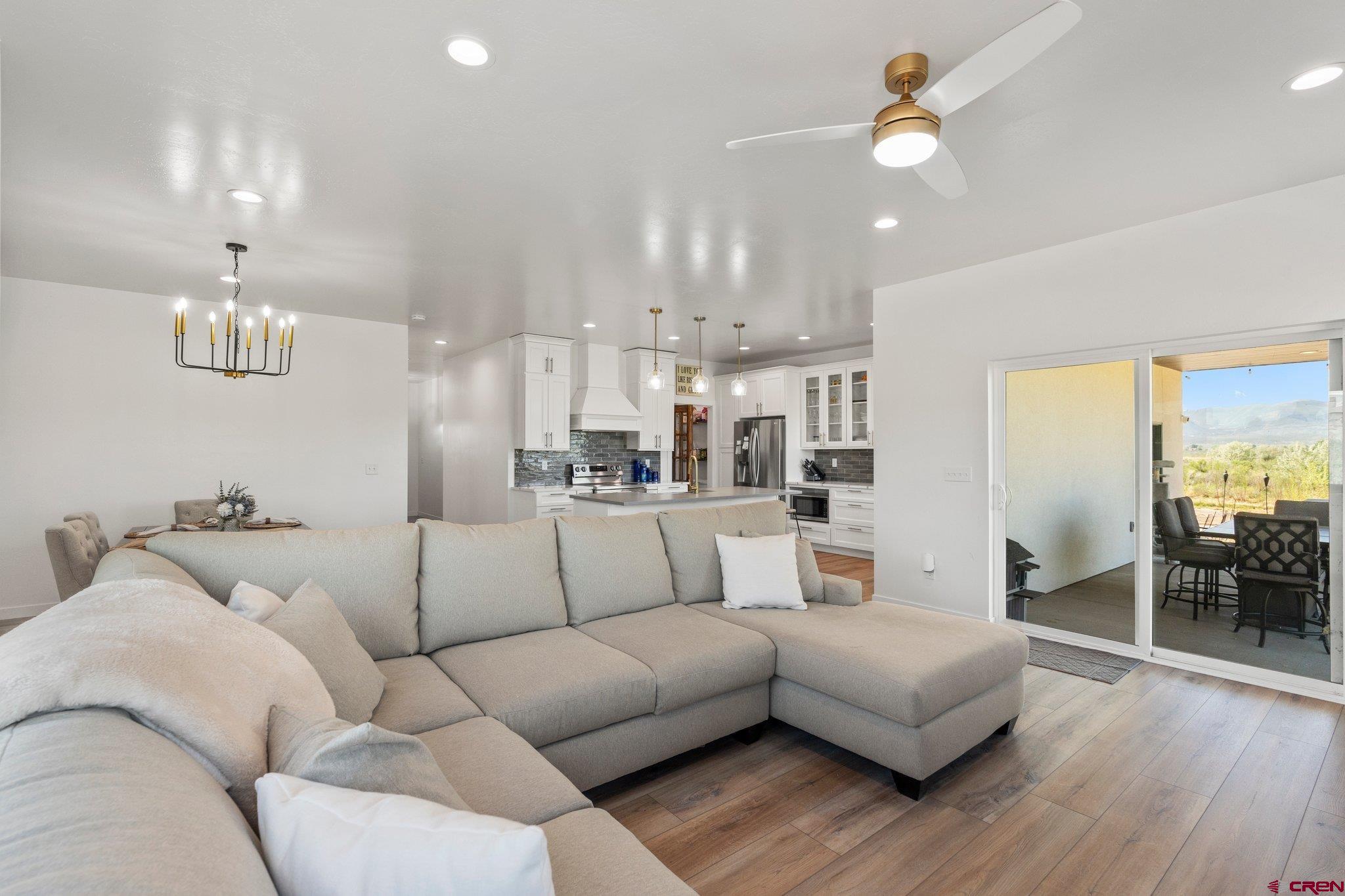 1517 Golf Course Lane Cortez, CO 81321 - Photo 5 of 41 a living room with furniture kitchen view and a wooden floor
