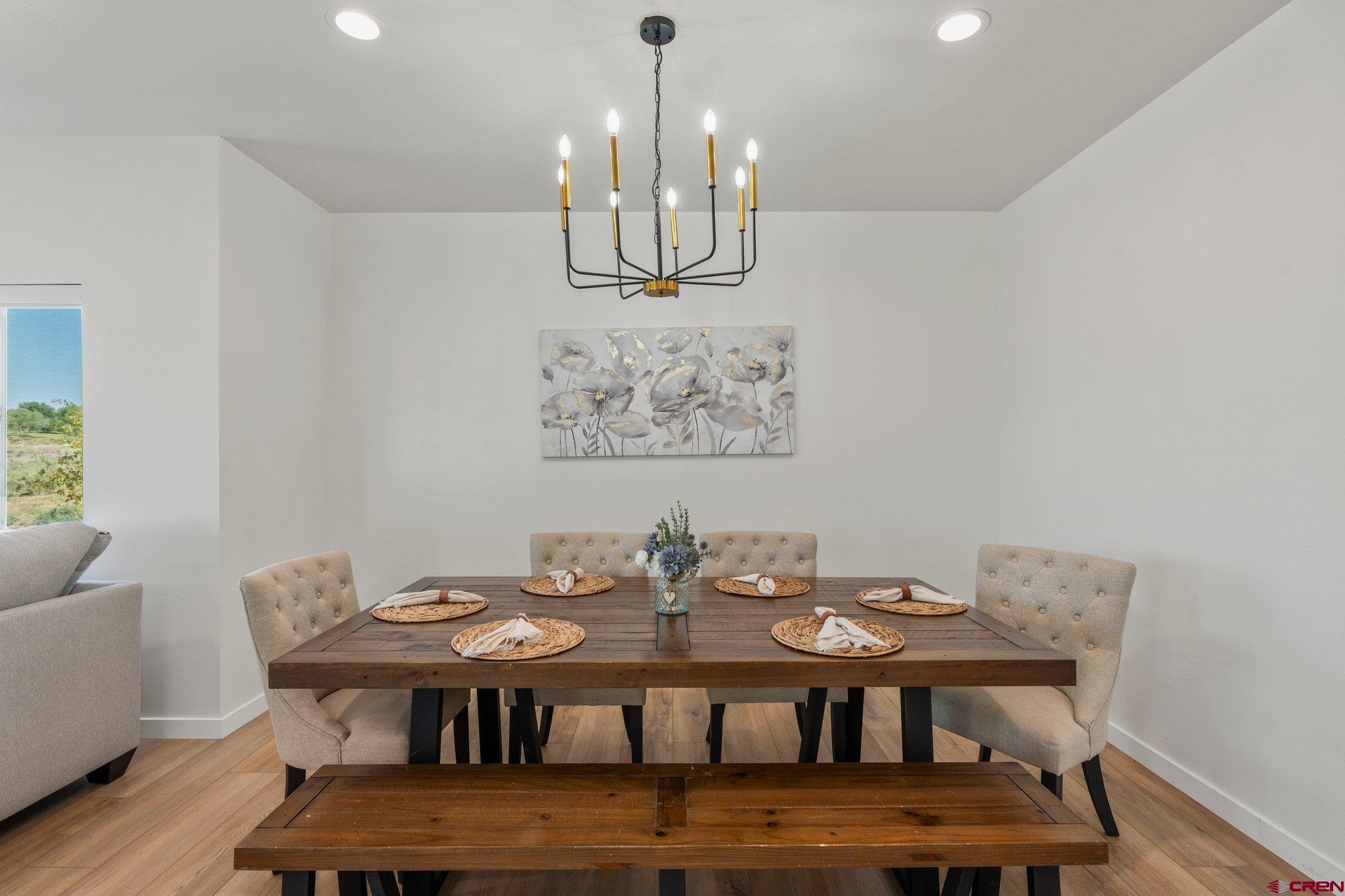1517 Golf Course Lane Cortez, CO 81321 - Photo 6 of 41 a view of a dining room with furniture and wooden floor
