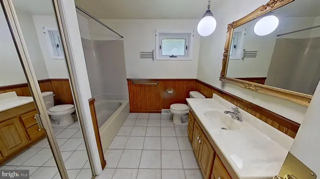 a room with a washing machine and wooden floor
