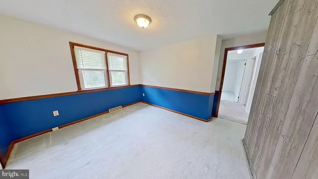 an empty room with windows and closet