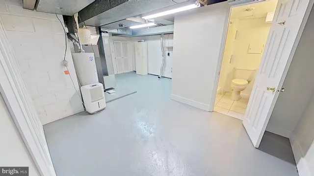 a view of a room with rack and a white door